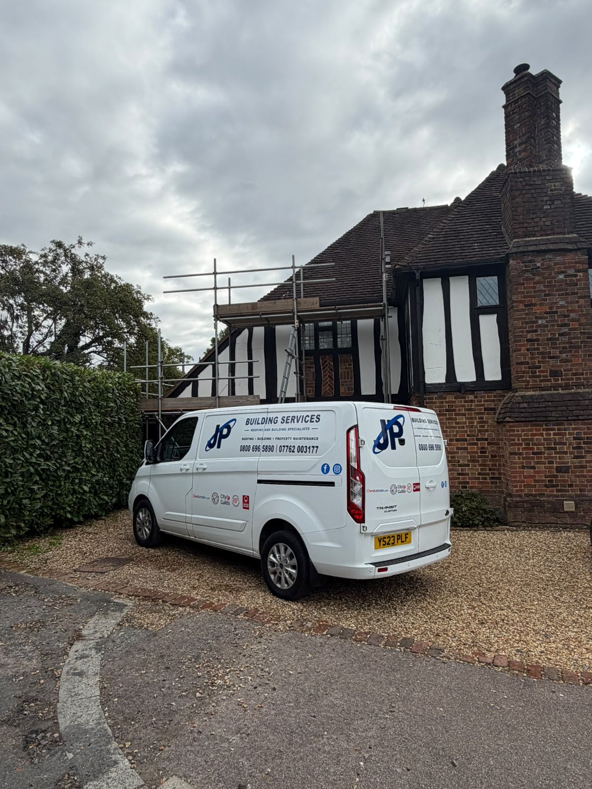 The J P Building Services van outside a completed roofing job